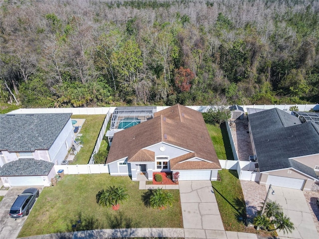 birds eye view of property with a view of trees