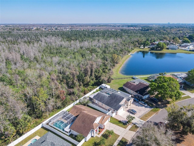 birds eye view of property featuring a water view and a view of trees