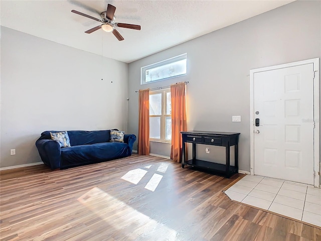 interior space featuring wood finished floors, a ceiling fan, and baseboards