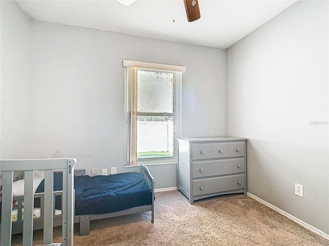 bedroom with baseboards, ceiling fan, and light colored carpet