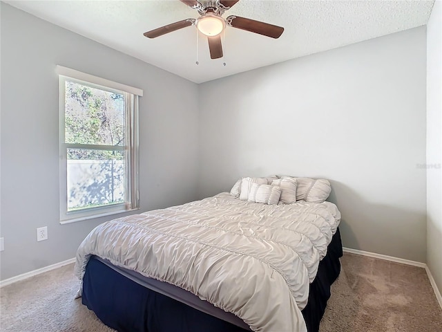 bedroom featuring ceiling fan, baseboards, and carpet flooring