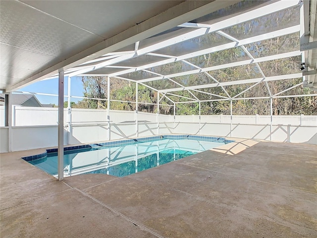 view of swimming pool featuring a fenced in pool, fence private yard, a patio area, and glass enclosure