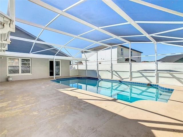 view of pool with glass enclosure, a patio area, and a fenced in pool