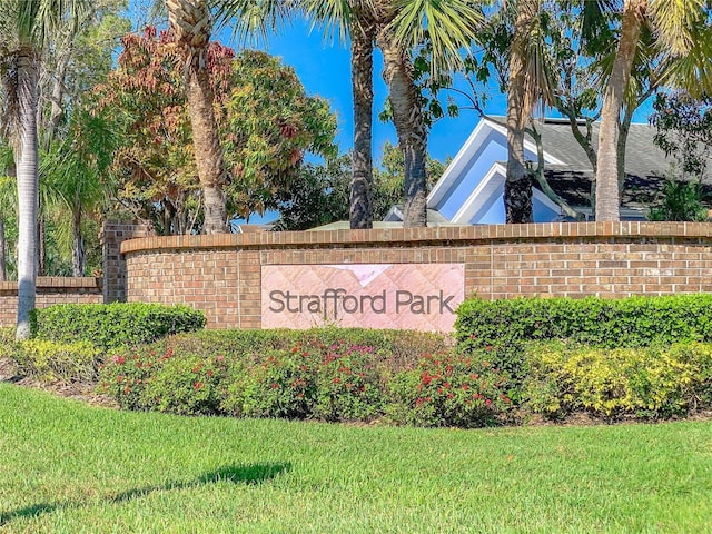 community sign featuring a lawn