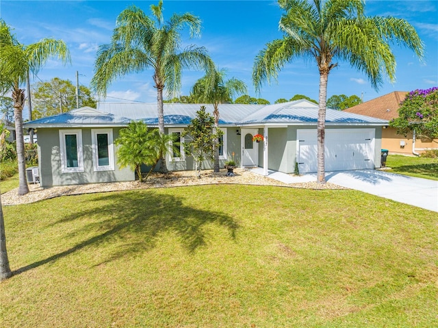 ranch-style home featuring stucco siding, a front yard, metal roof, a garage, and driveway