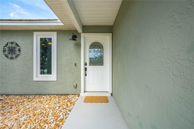 view of exterior entry featuring stucco siding