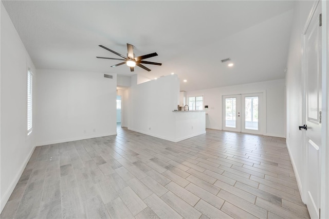 unfurnished living room featuring a ceiling fan, french doors, visible vents, and light wood finished floors