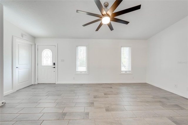 entrance foyer featuring light wood-type flooring, baseboards, and a ceiling fan