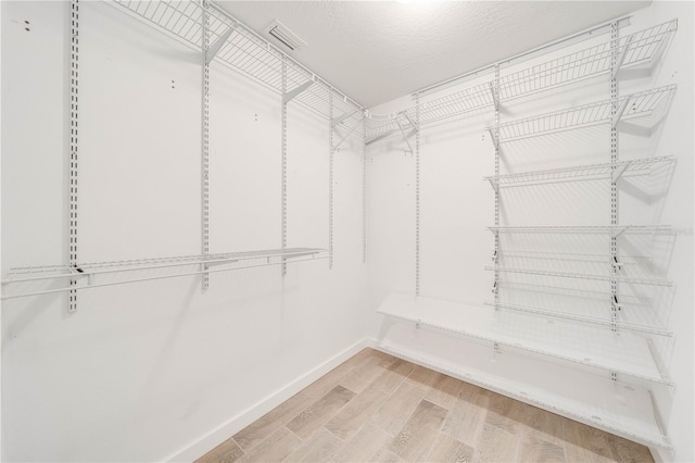 spacious closet with wood finished floors