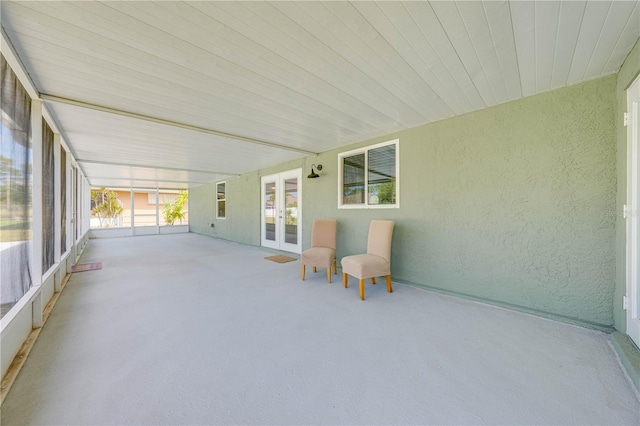 unfurnished sunroom with french doors