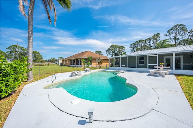 pool featuring a sunroom, fence, a patio, and a yard