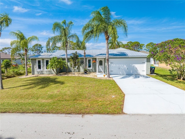 single story home with driveway, metal roof, an attached garage, a front yard, and stucco siding