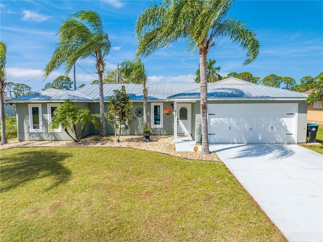 ranch-style home featuring concrete driveway, stucco siding, metal roof, an attached garage, and a front yard