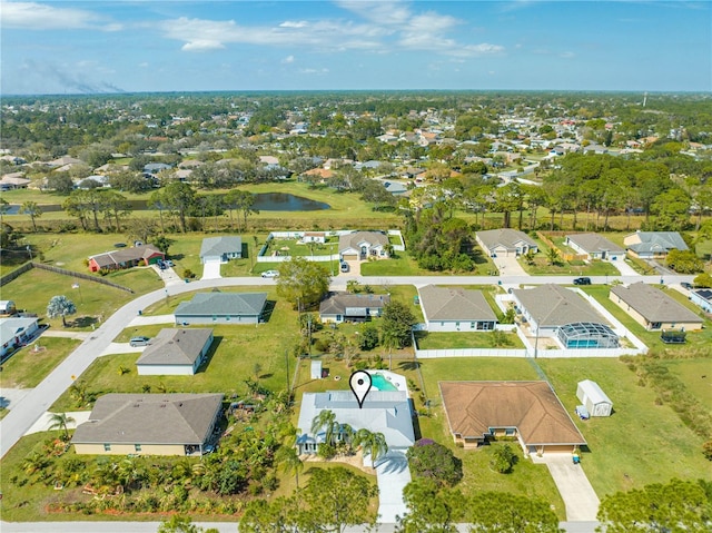 birds eye view of property with a residential view and a water view