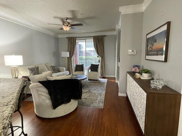 living area featuring dark wood-type flooring, crown molding, a textured ceiling, and baseboards