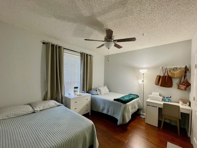 bedroom with dark wood-style floors, a ceiling fan, and a textured ceiling