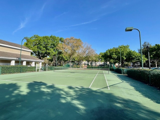 view of tennis court featuring fence