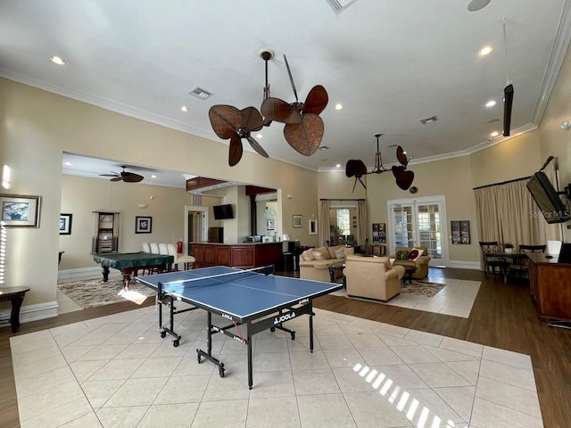 game room with crown molding, light tile patterned floors, recessed lighting, visible vents, and baseboards