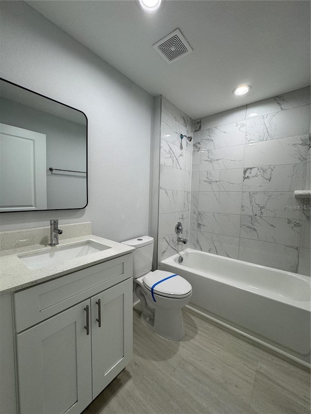 full bathroom with visible vents, toilet, vanity, washtub / shower combination, and recessed lighting