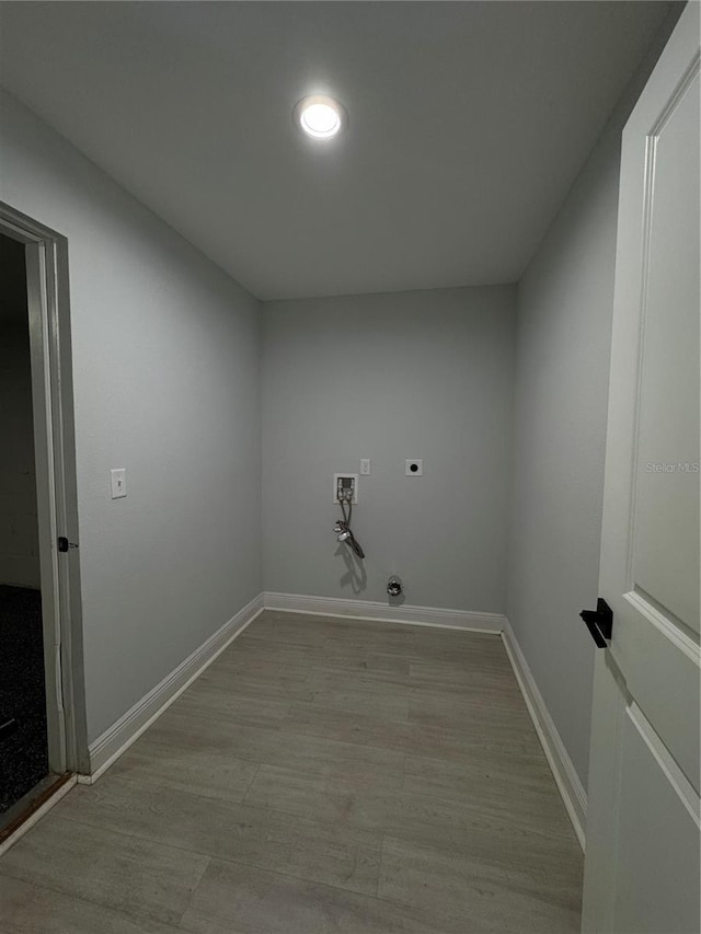 clothes washing area with laundry area, light wood finished floors, hookup for a washing machine, and hookup for an electric dryer