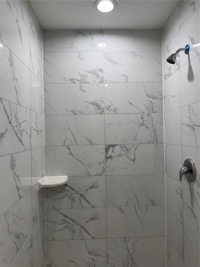 full bath with a tile shower