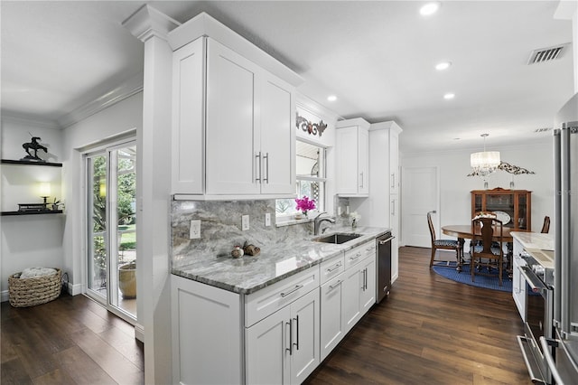 kitchen featuring white cabinets, visible vents, crown molding, and stainless steel dishwasher