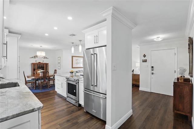 kitchen with visible vents, white cabinets, dark wood-style floors, stainless steel appliances, and crown molding