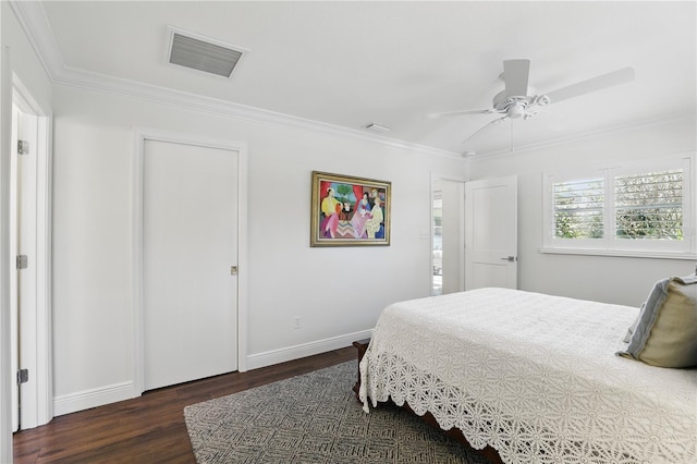 bedroom with baseboards, visible vents, a ceiling fan, ornamental molding, and wood finished floors