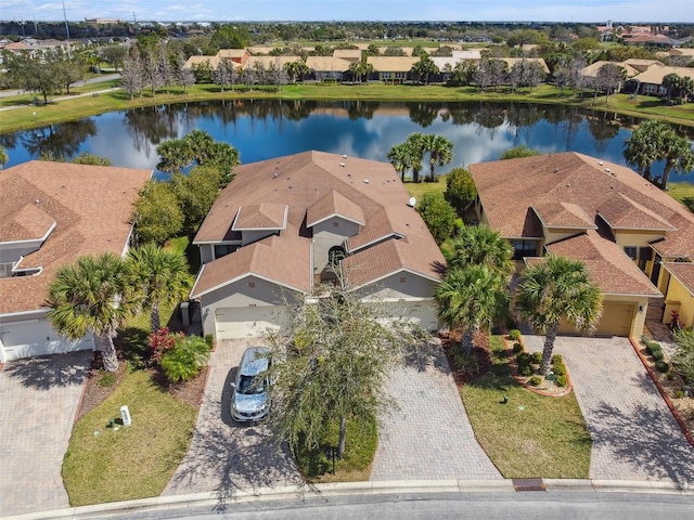 drone / aerial view with a residential view and a water view