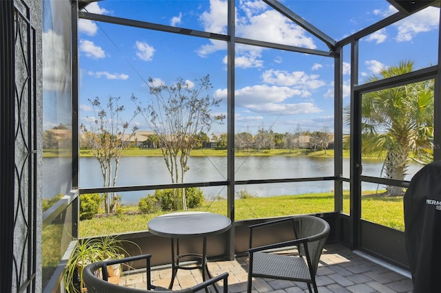 sunroom / solarium with a water view