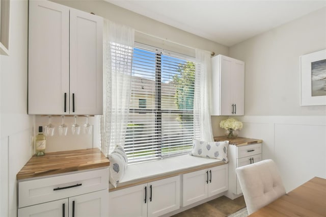 interior space with a wainscoted wall