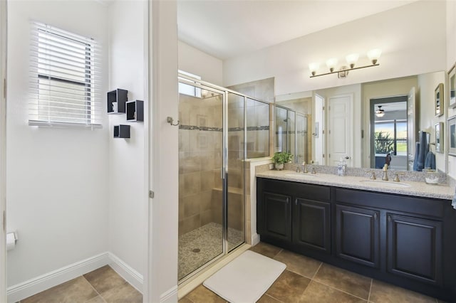 full bath featuring tile patterned floors, a sink, a shower stall, and double vanity