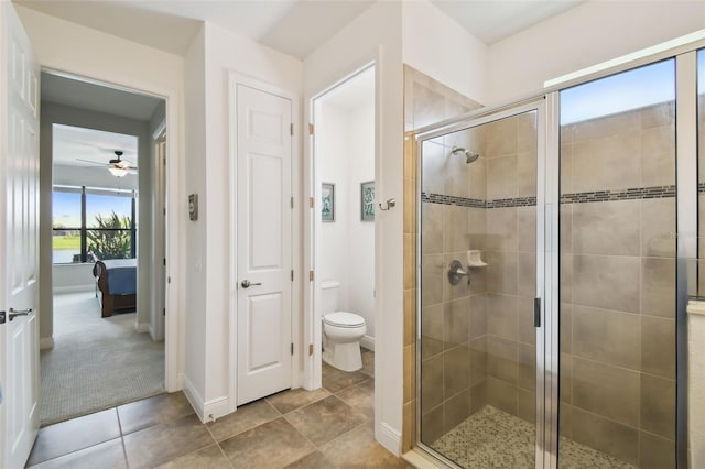 bathroom featuring baseboards, toilet, ensuite bath, tile patterned floors, and a shower stall