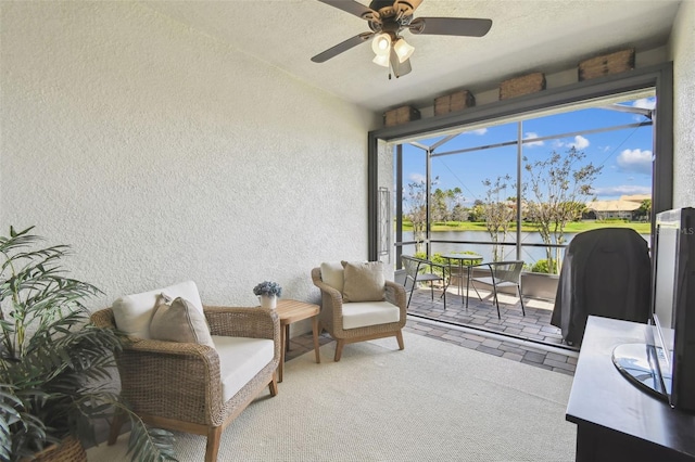 interior space with ceiling fan