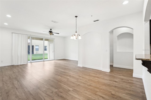 empty room featuring baseboards, light wood-style flooring, visible vents, and recessed lighting