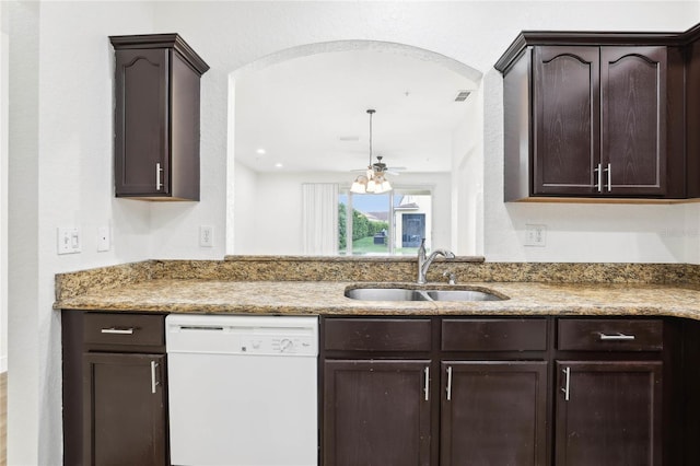 kitchen with white dishwasher, a sink, and dark brown cabinets