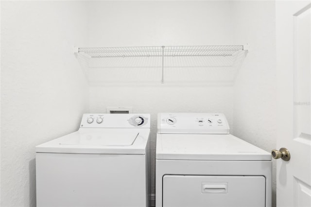 clothes washing area featuring laundry area and separate washer and dryer