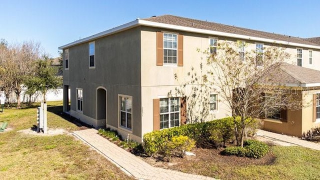 view of home's exterior featuring a yard and stucco siding