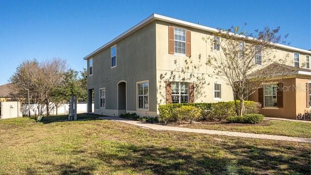 exterior space featuring a front yard and stucco siding