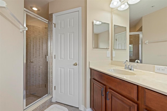 full bath featuring a stall shower and vanity