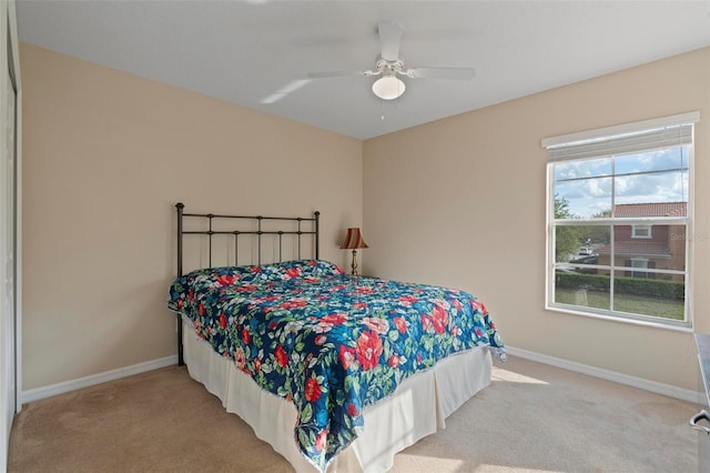 bedroom with ceiling fan, carpet floors, and baseboards