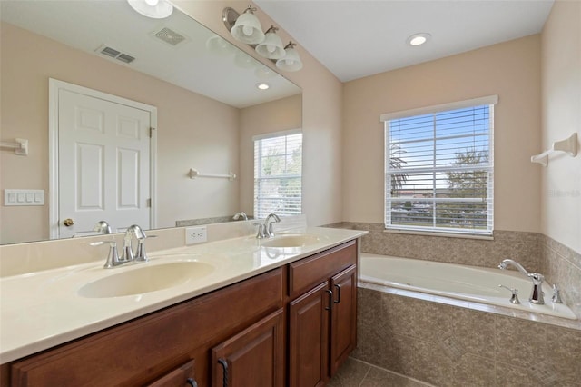 bathroom featuring visible vents, a sink, and double vanity