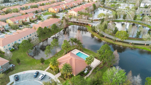 birds eye view of property with a water view and a residential view