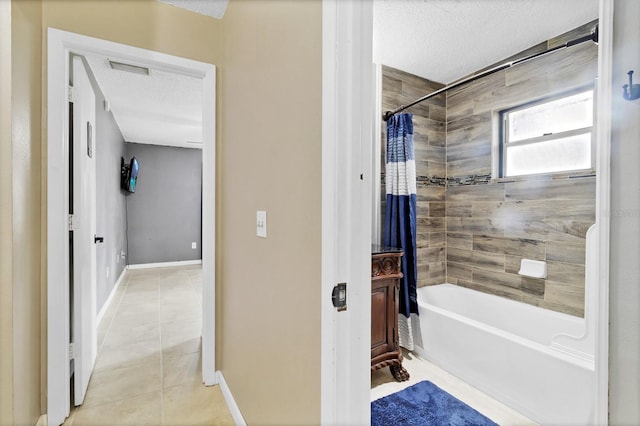 bathroom with visible vents, baseboards, shower / bath combo, tile patterned floors, and a textured ceiling