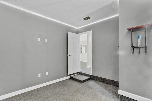 empty room featuring visible vents and baseboards