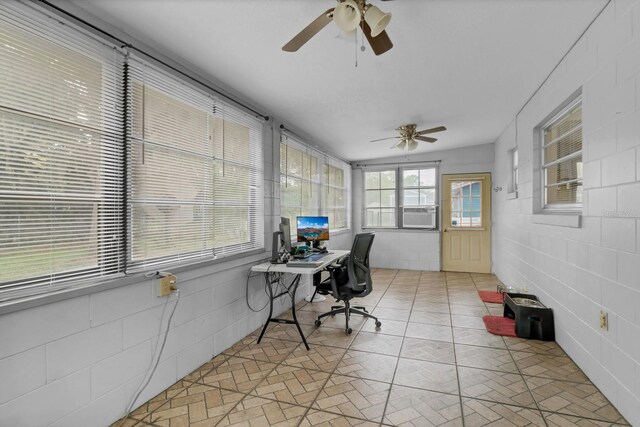 office space with cooling unit, a ceiling fan, and a sunroom