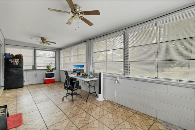 sunroom featuring ceiling fan