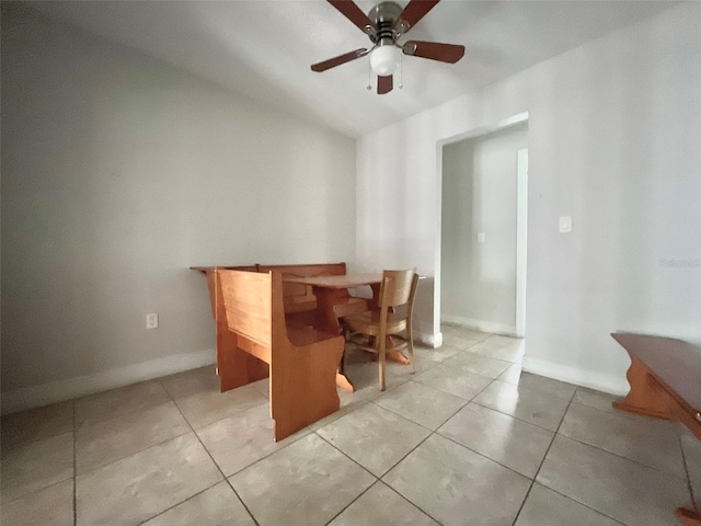 dining room with a ceiling fan, baseboards, and light tile patterned floors