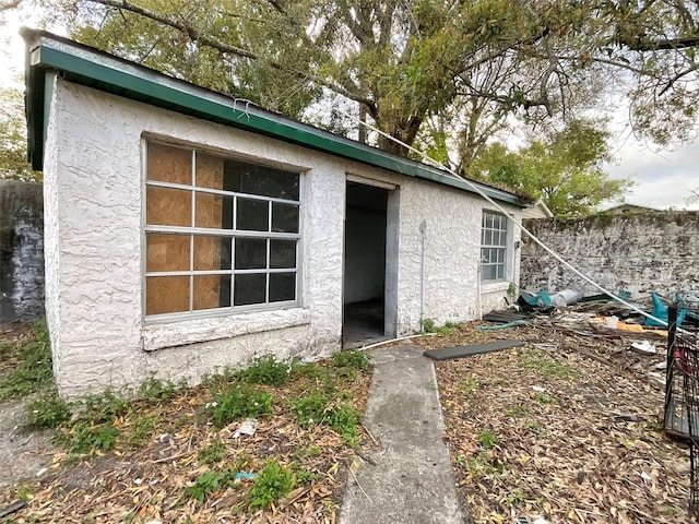 exterior space featuring fence and stucco siding