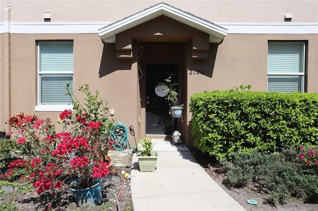 property entrance with stucco siding